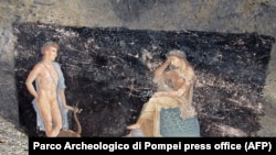 This handout picture released by the archaeological park of Pompeii on April 11, 2024, shows frescoes of the mythological characters Apollo and Cassandra that were painted on a banquet room wall in the ancient city of Pompeii near Naples, Italy.