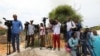 FILE - Somali journalists are seen during a stake-out on the outskirts of Mogadishu, Somalia, July 25, 2019.