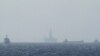 FILE - Ships and an oil rig, center, which China calls Haiyang Shiyou 981, and Vietnam refers to as Hai Duong 981, is seen in the South China Sea, off the shore of Vietnam, May 14, 2014.