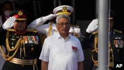 FILE- Sri Lankan President Gotabaya Rajapaksa sings the country's national anthem during Independence Day celebrations in Colombo, Feb. 4, 2022. Demonstrators have for months demanded Rajapaksa's resignation, blaming Sri Lanka's economic collapse on him a
