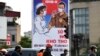 FILE - Motorists wearing face masks wait at a traffic light amid Vietnam's nationwide social isolation effort as a preventive measure against the spread of COVID-19 coronavirus in Hanoi, April 6, 2020.