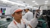 FILE - A manufacturer works at an assembly line of Vingroup's Vsmart phone in Hai Phong, Vietnam, Dec. 4, 2018.