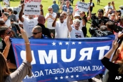Protesters clash with Trump supporters at a rally in West Palm Beach, Fla., Sept. 22, 2018, marking the one-year anniversary of Hurricane Maria's devastation of Puerto Rico.