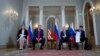 Russian President Vladimir Putin and U.S. President Donald Trump, with their interpreters at the beginning of their meeting at the Presidential Palace in Helsinki, Finland, July 16, 2018.