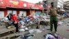 A policeman secures the scene of twin explosions at the Gikomba open-air market for second-hand clothes in Kenya's capital Nairobi, May 16, 2014.