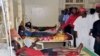 Government officials visit injured people from Tuesday's suicide bomb explosion, in a local hospital in Kano, Nigeria, Feb. 25, 2015.