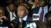 FILE - Congolese opponent Jean-Pierre Bemba, center, speaks to the press after applying to be a candidate for next presidential elections of December 23, at the office of the Independent Electoral Commission, in Kinshasa, Aug. 2, 2018.