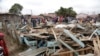 People and rescuers walk on debris of The Precious Talent Top School in Nairobi, Kenya, Sept. 23, 2019. 