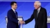 Democratic presidential candidates former South Bend Mayor Pete Buttigieg and Sen. Bernie Sanders, I-Vt., shake hands on stage Friday, Feb. 7, 2020, before the start of a Democratic presidential primary debate hosted by ABC News, Apple News, and…