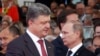 FILE - Ukraine's President-elect Petro Poroshenko, left, walks past Russian President Vladimir Putin during the commemoration of the 70th anniversary of the D-Day in Ouistreham, western France, June 6, 2014.