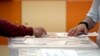FILE - An early voter casts his vote in the polling station on the outskirts of Sofia, Bulgaria, June 9, 2024.