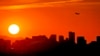 FILE - A jet takes flight from Sky Harbor International Airport as the sun sets over Phoenix, July 12, 2023.