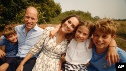 This photo provided by Kensington Palace on Sept. 9, 2024, shows Catherine, Princess of Wales, and Prince William with their children Prince George, right, Princess Charlotte and Prince Louis, left. (Will Warr/Kensington Palace via AP)