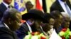 President of South Sudan, Salva Kiir signs a final power-sharing deal between South Sudanese arch-foes, Aug. 5, 2018, in Khartoum.