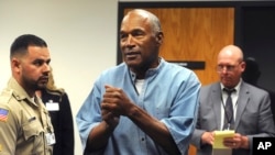 FILE - Former pro football star O.J. Simpson reacts after learning he was granted parole, at Lovelock Correctional Center in Lovelock, Nevada, July 20, 2017. 