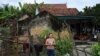 A Vietnamese woman stands outside her house in Yen Thanh district of Vietnam's Nghe An province, Oct. 27, 2019.