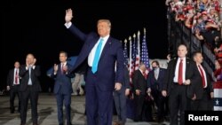 President Donald Trump waves before boarding Air Force One for a trip to Charlotte, NC, to deliver remarks on health care, Sept. 24, 2020, in Andrews Air Force Base, Md. 