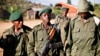 FILE - Child soldier, center, known as "Kadogo," meaning "small one" in Swahili, stands at the front line at Kanyabayonga in eastern Congo.