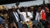 Opposition leader Raila Odinga holds a bible aloft after swearing an oath during a mock "swearing-in" ceremony at Uhuru Park in downtown Nairobi, Kenya, Jan. 30, 2018.