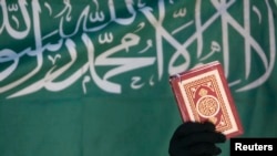 FILE - A Virginia social studies class learning about Arabic calligraphy was told to write "There is no god but Allah and Muhammad is the messenger of Allah." That message is seen here, from a 2008 banner in Sana'a.