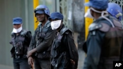 Riot police wear face masks on the streets of Harare, Zimbabwe, Tuesday, March 31, 2020. Zimbabwe went into a lockdown for 21 days in an effort to curb the spread of the coronavirus. The new coronavirus causes mild or moderate symptoms for most…