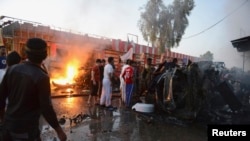 Site of car bombing along street lined with shops, Samarra, Iraq, Oct.12, 2013.