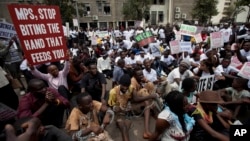 Kenyan demonstrators, some chained to each other, gather near the gate of parliament in Nairobi, Kenya, May 14, 2013.