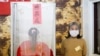 A Taiwanese voter stands at a polling booth during the general elections in Kaohsiung, Taiwan, Jan. 11, 2020. 