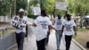 FILE - Supporters of former President Donald Trump with signs and T-shirts that read "Blacks for Trump" gather near the E. Barrett Prettyman U.S. Federal Courthouse, in Washington, Aug. 3, 2023.
