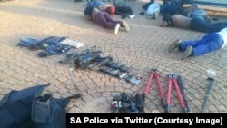 South Africa police arrest dozens and seize guns at a church