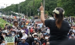 A protester gestures as she talks to the crowd during an anti-terror bill rally at the University of the Philippines in Manila, Philippines as they observe Philippine Independence Day on Friday, June 12, 2020.