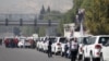 FILE - A convoy consisting of Red Cross, Red Crescent and United Nation (UN) gather before heading toward Madaya from Damascus, and to al Foua and Kefraya in Idlib province, Syria, Jan. 11, 2016.