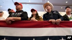 ARCHIVO - Los miembros de la audiencia escuchan al expresidente Donald Trump hablar durante un mitin de compromiso con el caucus, el miércoles 13 de diciembre de 2023, en Coralville, Iowa.
