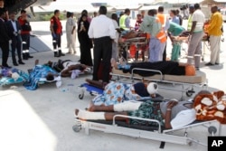 FILE - People critically wounded in an Oct. 14 truck bombing wait to be moved into a plane to be airlifted for treatment in Turkey, in Mogadishu, Somalia, Oct, 16, 2017.