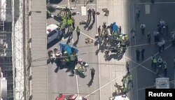 Police and emergency services attend to the scene of an incident involving a vehicle on Flinders Street, as seen from Swanson Street, in Melbourne, Australia, Dec. 21, 2017.