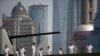 FILE - Crew members of the Australian HMAS Ballarat, ANZAC-class Guided Missile Frigate, stand at attention on the deck as they arrive at a port area of Huangpu River in Shanghai, May 17, 2012. 