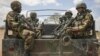 In this photo released by the African Union-UN Information Support Team, Kenyan soldiers serving with the African Union Mission in Somalia at their sector headquarters in the town of Dhobley, Somalia, September 30, 2012. 