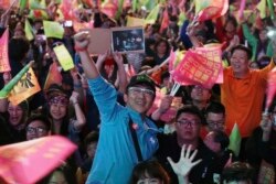 Supporters of Taiwan's 2020 presidential election candidate, Taiwan president Tsai Ing-wen cheer for Tsai's victory in Taipei, Taiwan, Jan. 11, 2020.