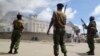 FILE - Armed police guard the Salvation Army Church after it was set on fire by rioting youths, following Friday Muslim prayers in Mombasa, Kenya, Oct. 4, 2013.