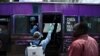A government health official sprays a chlorine solution on a public transport vehicle as a preventive measure against the COVID-19 coronavirus in Nairobi, March 19, 2020.