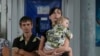 Local residents wait for a bus as they try flee fighting in the eastern Ukrainian city of Slovyansk June 10, 2014.