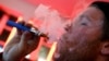 A customer puffs on an e-cigarette at the Henley Vaporium in New York City December 18, 2013. At the Henley Vaporium, one of a growing number of e-cigarette lounges sprouting up in New York and other U.S. cities, patrons can indulge in their choice of mor