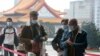 People wear face masks to protect against the spread of the coronavirus as they visit the Chiang Kai-shek Memorial Hall in Taipei, Taiwan, Thursday, Feb. 27, 2020. 