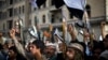 Shiite rebels, known as Houthis, hold up their weapons as they attend a protest against Saudi-led airstrikes in Sanaa, Yemen, April 10, 2015. 