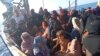 A boat carrying Rohingya refugees, including women and children, is seen stranded in waters off the coast of Bireuen, Aceh province, Indonesia, December 27, 2021, in this still image taken from a video. (Aditya Setiawan via REUTERS)